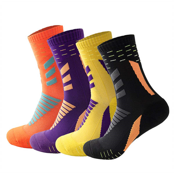 Collection of colorful ankle socks in orange, purple, yellow, and black with dynamic geometric patterns.