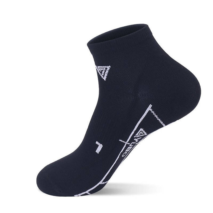 A single black ankle sock with a white geometric pattern design.