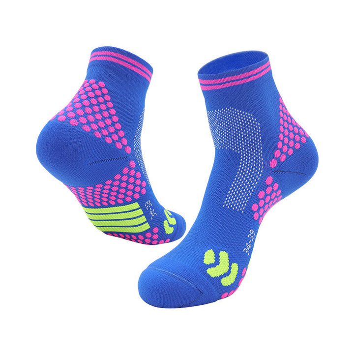 Blue athletic ankle socks with pink hexagonal grip patterns and lime green arch support bands.