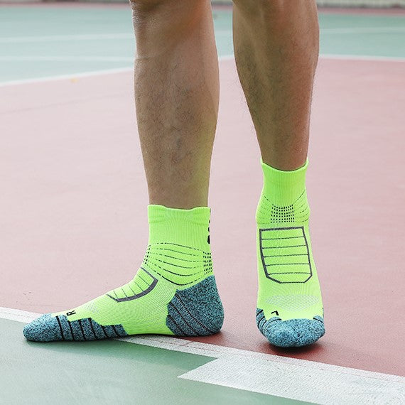 Wearing bright yellow and blue color-blocked cushioned golf socks, ideal for sports surfaces-1.