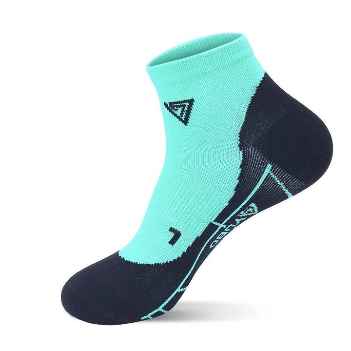 A single green ankle sock with a white geometric pattern design.
