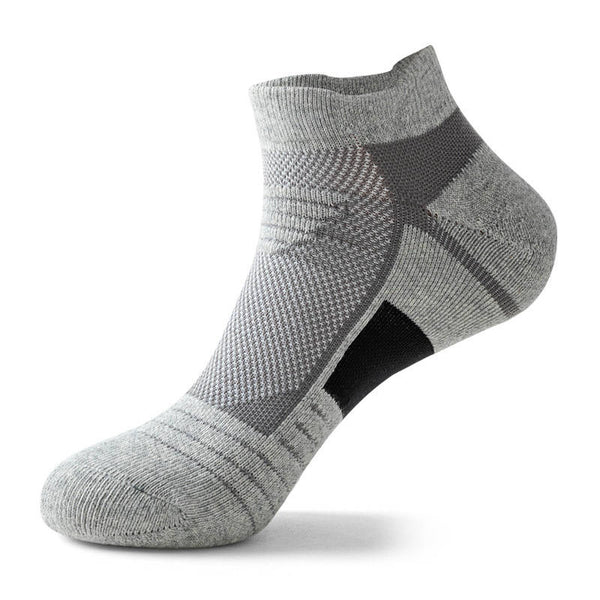 Grey ankle sock with a white patch on the foot arch, isolated on a white background.