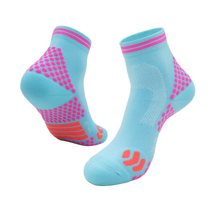 Light blue athletic ankle socks with pink grip dots and coral highlights on the heel and toe areas.