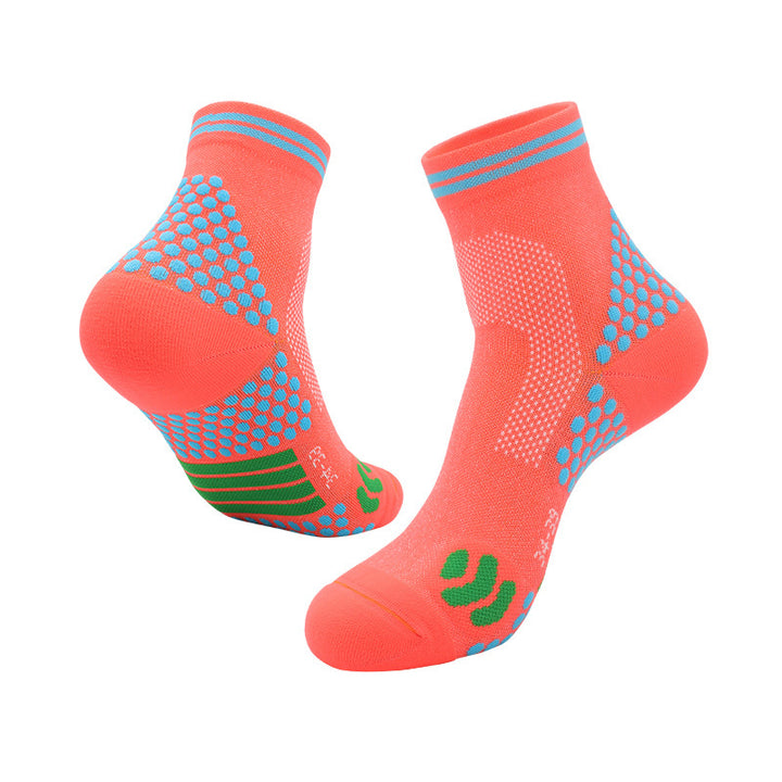 Orange athletic ankle socks with blue accents, grip dots on the sole, and green elastic arch support