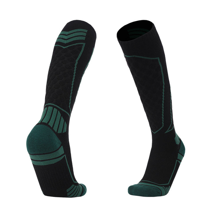 Thick padded merino wool skiing over-the-calf socks in black and green for warmth and comfort.