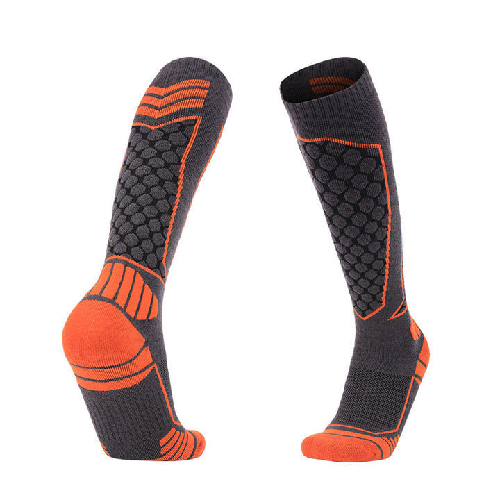 Thick padded merino wool skiing over-the-calf socks with orange accents for warmth and comfort.