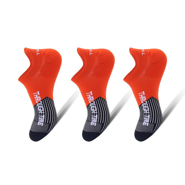 Three red ankle socks with black patterns on the sole, displayed on a white background.