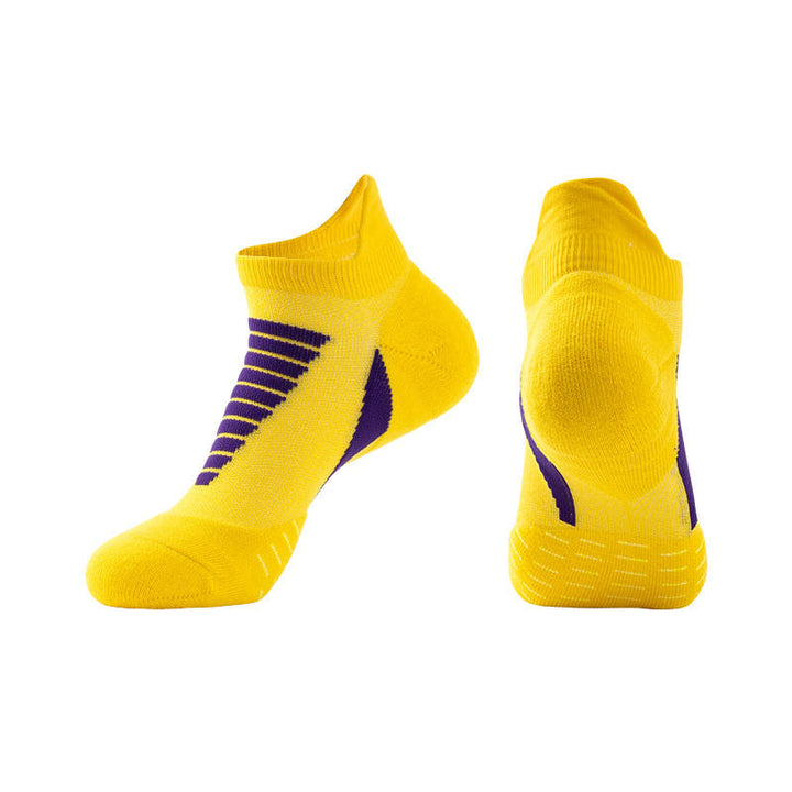 Bright yellow ankle socks with purple stripes and heel detail on a white background.